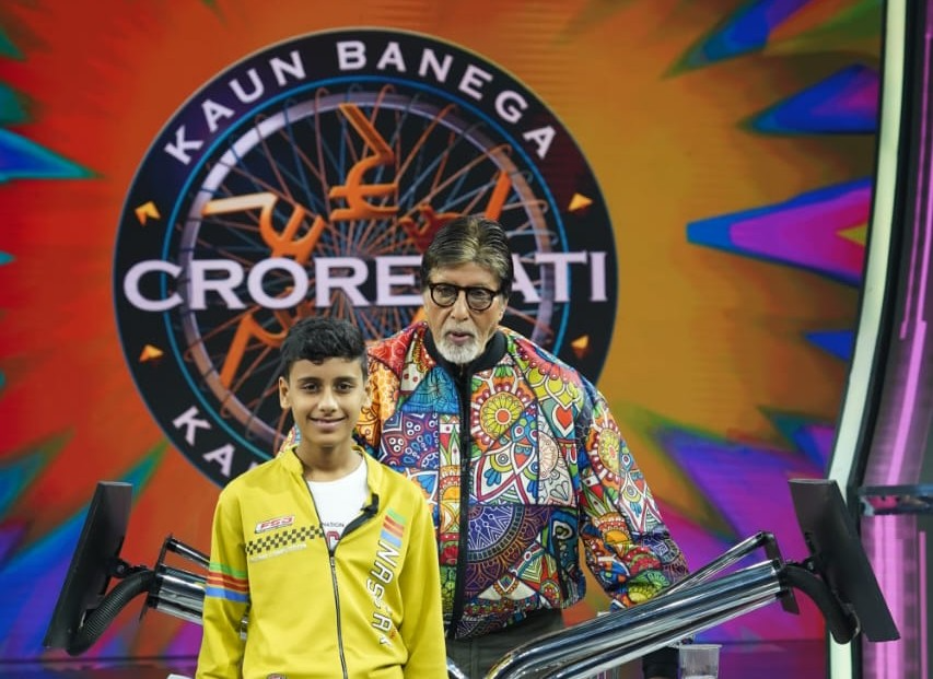 Young student showing medal and certificate of appreciation